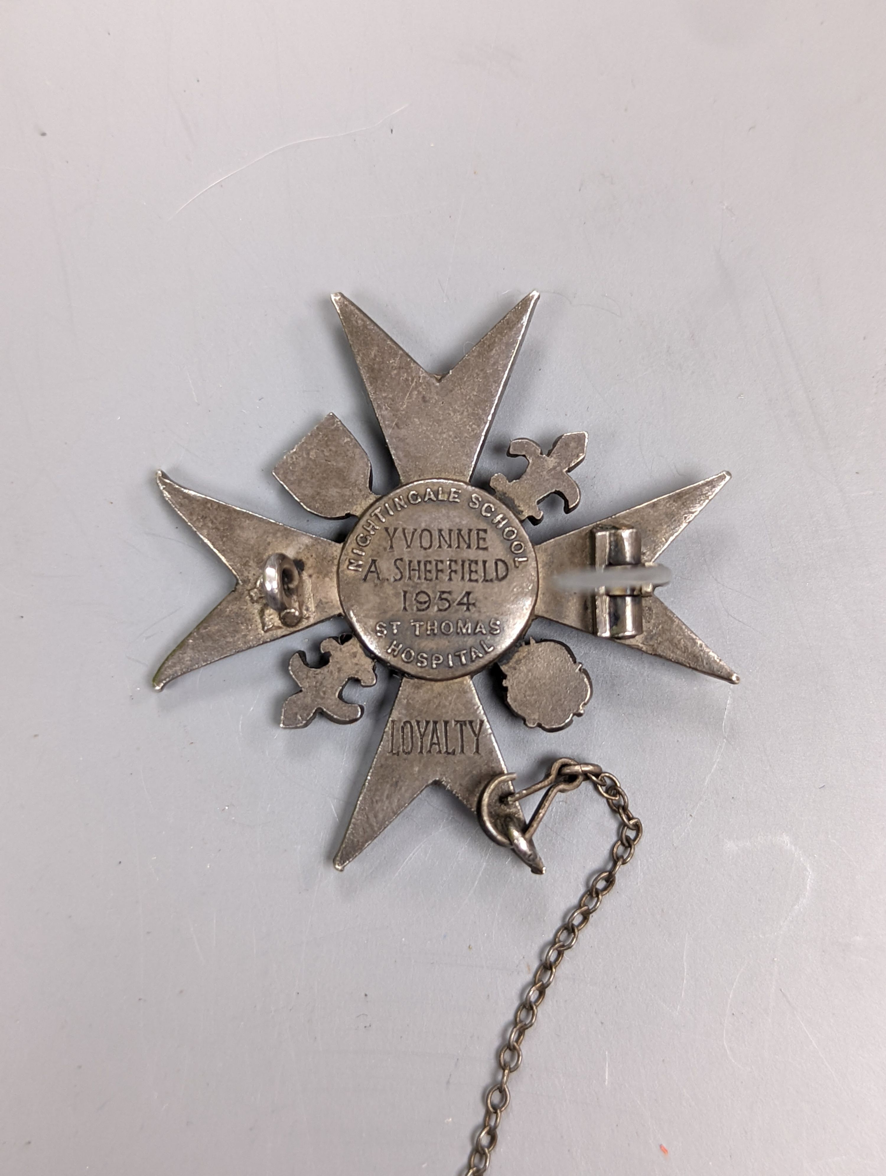 An enamelled Nightingale School, St. Thomas Hospital Loyalty badge, 1954, 37mm.